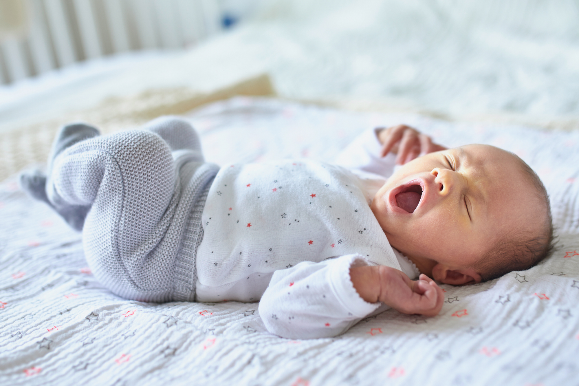 newborn baby having a big yawn