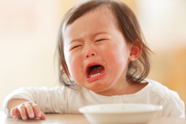 highly sensitive child upset with tears at the table