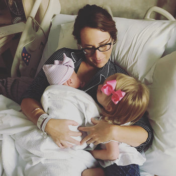 New mom in hospital with newborn and big sister