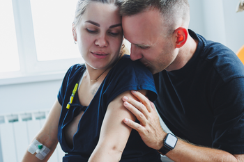 birthing partner supported by partner during labor