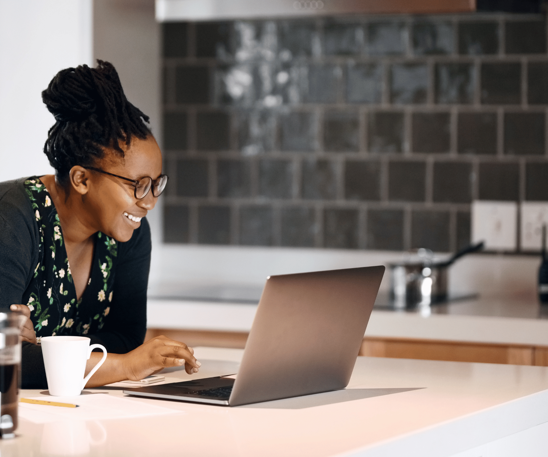  Expecting couple preparing for baby, with mother holding baby booties and father holding a onesie on a bed.